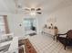 Cozy dining room featuring tile floors, a ceiling fan, and bright natural lighting at 12139 Palmetto Way, Dunnellon, FL 34432