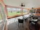 Relaxing sunroom with ample seating and serene views of the surrounding landscape at 12139 Palmetto Way, Dunnellon, FL 34432