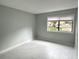 Bright bedroom featuring neutral paint, sleek tile floors, and a window offering natural light at 5789 Windhover Dr # E03, Orlando, FL 32819