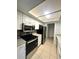 Modern kitchen featuring stainless steel appliances, granite countertops, and ample cabinet space at 5789 Windhover Dr # E03, Orlando, FL 32819