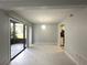 Bright open floorplan with access to a screened patio and view of the kitchen at 5789 Windhover Dr # E03, Orlando, FL 32819