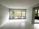 Bright living room with large windows providing ample natural light and scenic views at 5789 Windhover Dr # E03, Orlando, FL 32819