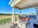 Outdoor seating on a tiled balcony with views of a golf course at 7405 Excitement Dr, Kissimmee, FL 34747