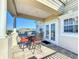 Balcony with a table, chairs, decorative columns, and a picturesque neighborhood view at 7405 Excitement Dr, Kissimmee, FL 34747