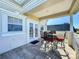 A tiled balcony with outdoor seating, white railings, and bright daylight at 7405 Excitement Dr, Kissimmee, FL 34747