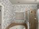 Bathroom showcasing a shower, bathtub, floral wallpaper and a window with blind at 7405 Excitement Dr, Kissimmee, FL 34747