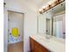 Bathroom featuring a vanity with a large mirror and Minion cartoon on the wall at 7405 Excitement Dr, Kissimmee, FL 34747