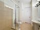 Bathroom features a glass-enclosed shower, decorative tile accents, and a pedestal sink at 7405 Excitement Dr, Kissimmee, FL 34747