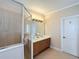 Well-appointed bathroom featuring double sinks, a tiled shower, and neutral finishes for a clean, modern look at 7405 Excitement Dr, Kissimmee, FL 34747