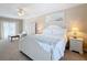 Bright primary bedroom with white furniture, a king size bed, and carpeted floors at 7405 Excitement Dr, Kissimmee, FL 34747