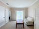 Comfortable bedroom with natural light, sitting area, and balcony access at 7405 Excitement Dr, Kissimmee, FL 34747