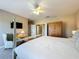 Bedroom features a four-poster bed, ceiling fan, wood armoire, and an accent chair with side table at 7405 Excitement Dr, Kissimmee, FL 34747