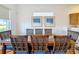 Bright dining room featuring a glass-top table with seating for six and views of the yard at 7405 Excitement Dr, Kissimmee, FL 34747