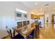 Bright dining room featuring a glass-top table with seating for six and views into the kitchen at 7405 Excitement Dr, Kissimmee, FL 34747