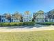 Row of charming two-story townhouses with manicured lawns at 7405 Excitement Dr, Kissimmee, FL 34747