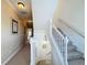 Bright hallway and staircase with neutral walls, carpet, and decorative wall art at 7405 Excitement Dr, Kissimmee, FL 34747