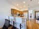 The kitchen includes a breakfast bar with white bar stools, wood cabinets, and stainless steel appliances at 7405 Excitement Dr, Kissimmee, FL 34747