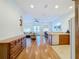 Spacious living area with hardwood floors seamlessly connects to the dining area and kitchen at 7405 Excitement Dr, Kissimmee, FL 34747