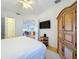 Bright main bedroom with TV and large wardrobe storage and an ensuite bath at 7405 Excitement Dr, Kissimmee, FL 34747