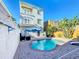 Exterior view of a pool area, showcasing the pool, pool chairs and the building at 7405 Excitement Dr, Kissimmee, FL 34747