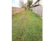 Long grassy backyard with wooden fences on either side at 1609 Little Falls Cir # 79, Orlando, FL 32807