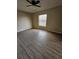 Spacious bedroom with ceiling fan and wood-look floors at 1609 Little Falls Cir # 79, Orlando, FL 32807