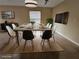 Virtually staged dining room with large table, black and white chairs at 1609 Little Falls Cir # 79, Orlando, FL 32807