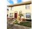 Two-story stucco home with a red tile roof and a small front yard at 1609 Little Falls Cir # 79, Orlando, FL 32807