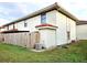 Rear view of home showcasing a wooden privacy fence and AC unit at 1609 Little Falls Cir # 79, Orlando, FL 32807
