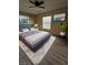 Main bedroom with ceiling fan and wood-look floors at 1609 Little Falls Cir # 79, Orlando, FL 32807