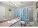 Bathroom with a tiled shower and tub and a blue patterned shower curtain at 5578 Metrowest Blvd # 101, Orlando, FL 32811