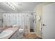 Bathroom featuring a single sink vanity, shower with beach-themed curtain, and tile floors at 5578 Metrowest Blvd # 101, Orlando, FL 32811