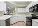 Well-lit kitchen featuring white cabinets, modern appliances, and tile flooring at 5578 Metrowest Blvd # 101, Orlando, FL 32811