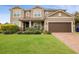 Two-story house with brown garage door and manicured lawn at 752 Sandy Bar Dr, Winter Garden, FL 34787