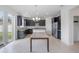 Modern kitchen with dark cabinetry, granite counters, and stainless steel appliances at 752 Sandy Bar Dr, Winter Garden, FL 34787