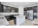 Modern kitchen with dark cabinetry, granite counters, and stainless steel appliances at 752 Sandy Bar Dr, Winter Garden, FL 34787