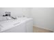 Bright laundry room with white washer and dryer at 752 Sandy Bar Dr, Winter Garden, FL 34787
