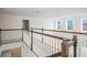 Open loft area with wood railing and carpet at 752 Sandy Bar Dr, Winter Garden, FL 34787