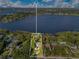 Expansive aerial view of a lakeside home showcasing lush landscaping and scenic water views at 1003 Oakdale St, Windermere, FL 34786