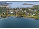 Aerial view of property with lake frontage and mature trees at 1003 Oakdale St, Windermere, FL 34786