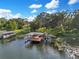 Aerial view of covered boat dock with lift on the lake at 1003 Oakdale St, Windermere, FL 34786