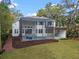 Aerial view of the home's backyard, screened pool, covered outdoor area, and landscaping at 1003 Oakdale St, Windermere, FL 34786