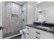Elegant bathroom features a tiled walk-in shower, marble countertop, and stylish fixtures for a luxurious feel at 1003 Oakdale St, Windermere, FL 34786