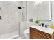Modern bathroom features a walk-in shower, sleek vanity with wood accents, and a stylish, lighted mirror at 1003 Oakdale St, Windermere, FL 34786