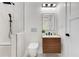 Stylish bathroom with a walk-in shower, contemporary vanity, sleek fixtures, and an elegant, lighted mirror at 1003 Oakdale St, Windermere, FL 34786
