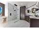 Modern bathroom with a large glass shower, dark wood cabinets, and marble countertops at 1003 Oakdale St, Windermere, FL 34786