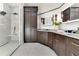 Spacious bathroom showcasing sleek dark wood cabinetry and a luxurious glass shower at 1003 Oakdale St, Windermere, FL 34786