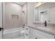 Modern bathroom with a shower-tub combo, white marble vanity, and sleek black hardware at 1003 Oakdale St, Windermere, FL 34786