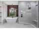 Spa-like bathroom with a freestanding tub, glass-enclosed shower, and modern chandelier for a relaxing experience at 1003 Oakdale St, Windermere, FL 34786