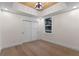 Cozy bedroom with hardwood floors, wood paneled ceiling, natural light, and closet at 1003 Oakdale St, Windermere, FL 34786